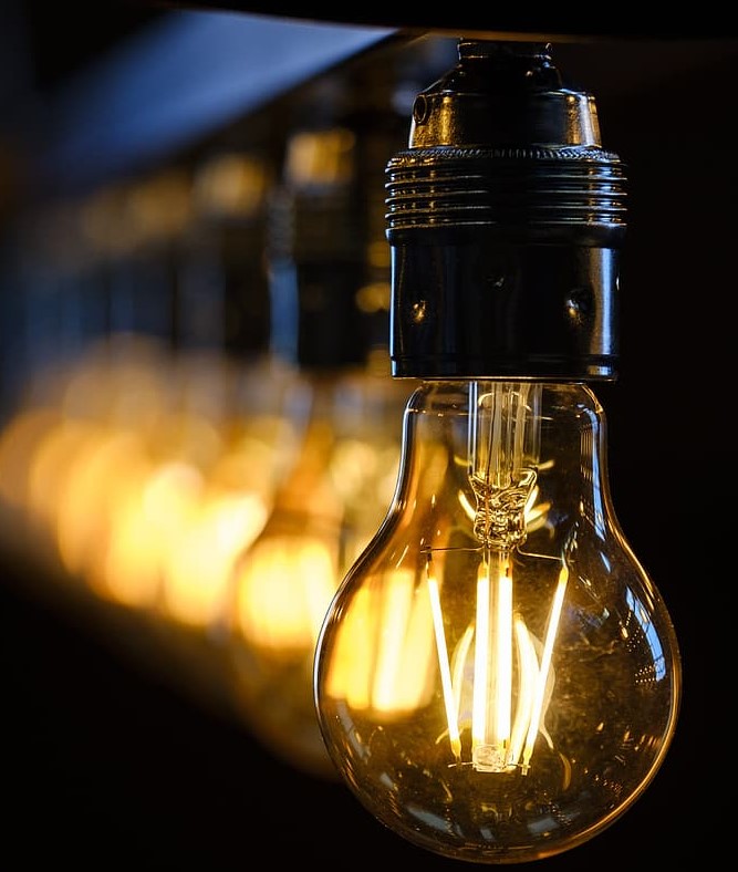 Image of a line of light bulbs one if front of the other