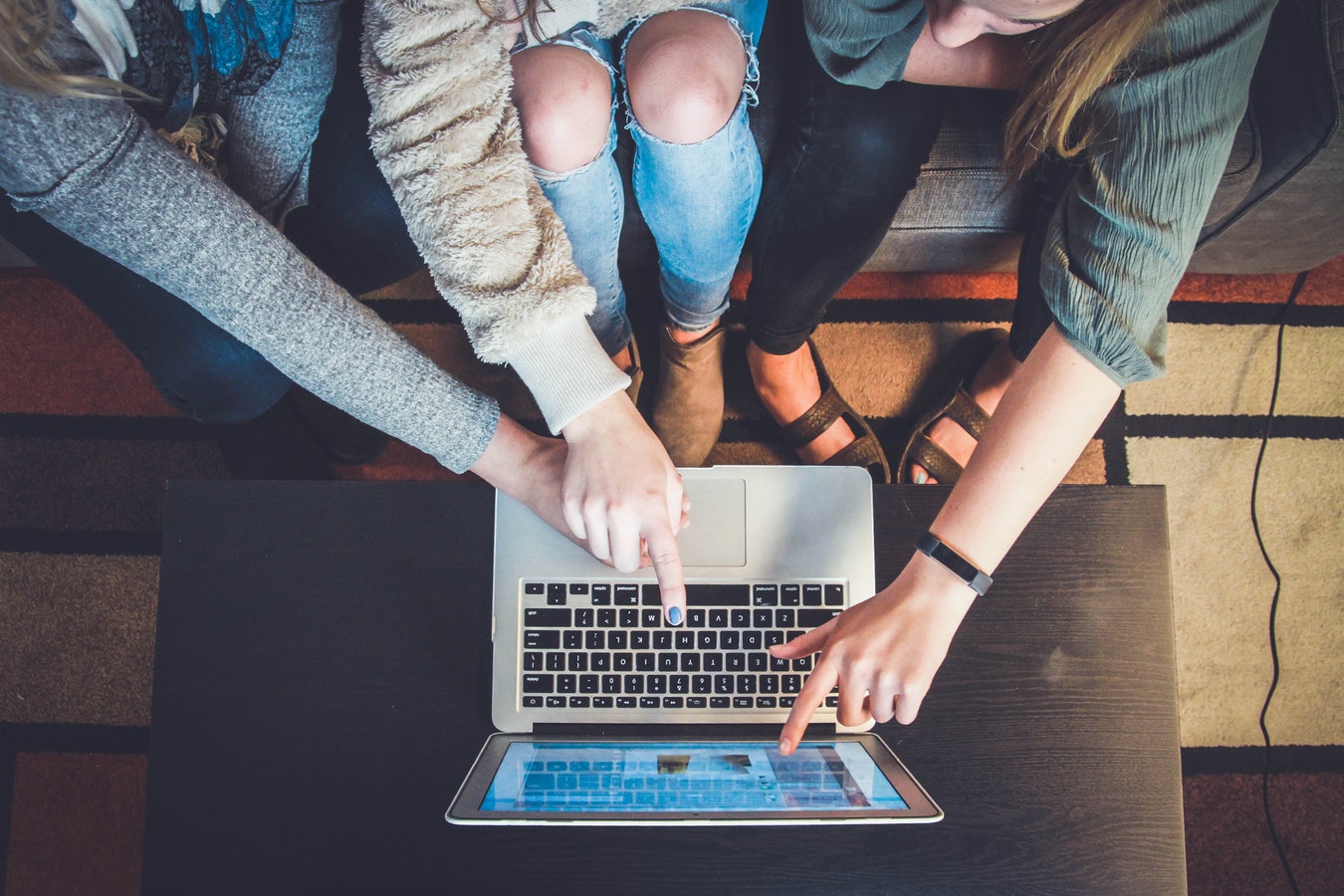 People pointing at a computer screen