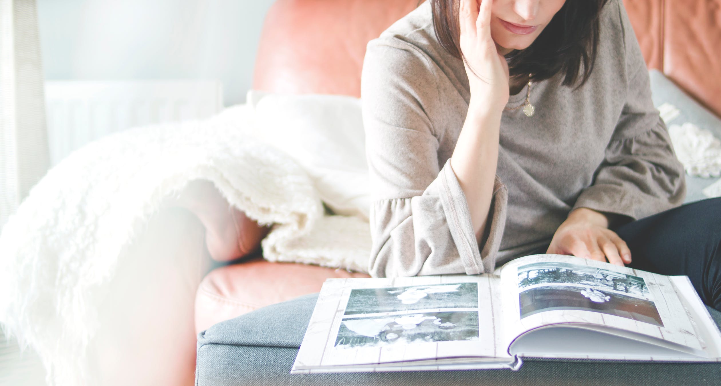 Image of a woman looking through a photo album