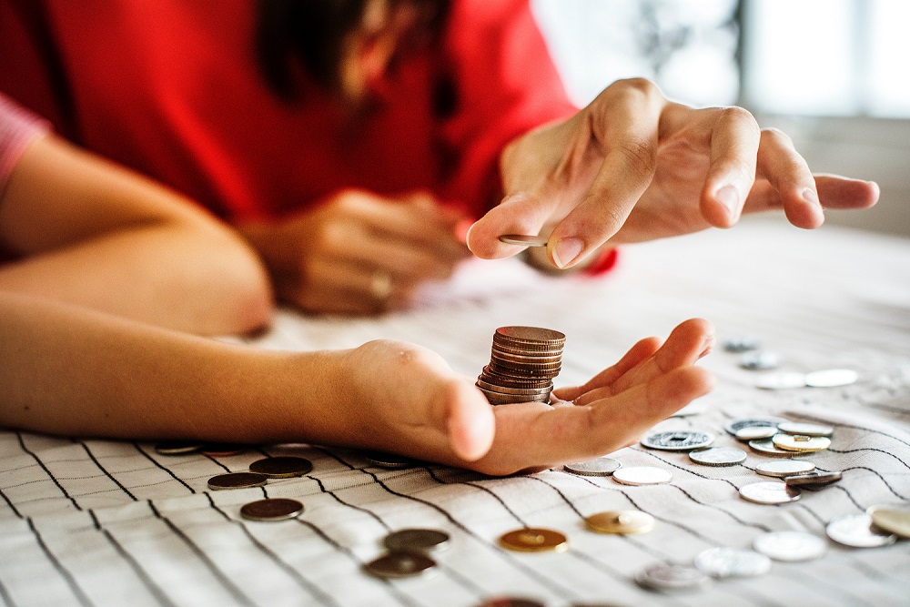 Person with a hand full of coins