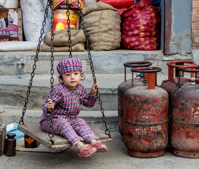 A child plays in a marketplace in Kathmandu, Nepal