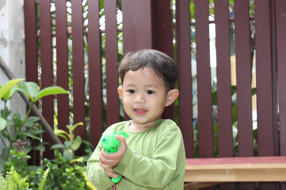 Child with a toy gun. 