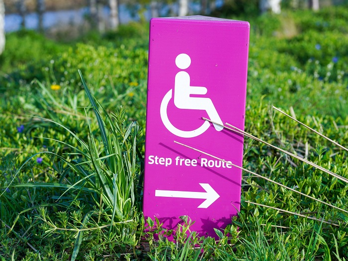 A sign with the wheelchair user symbol reads "Step free Route"